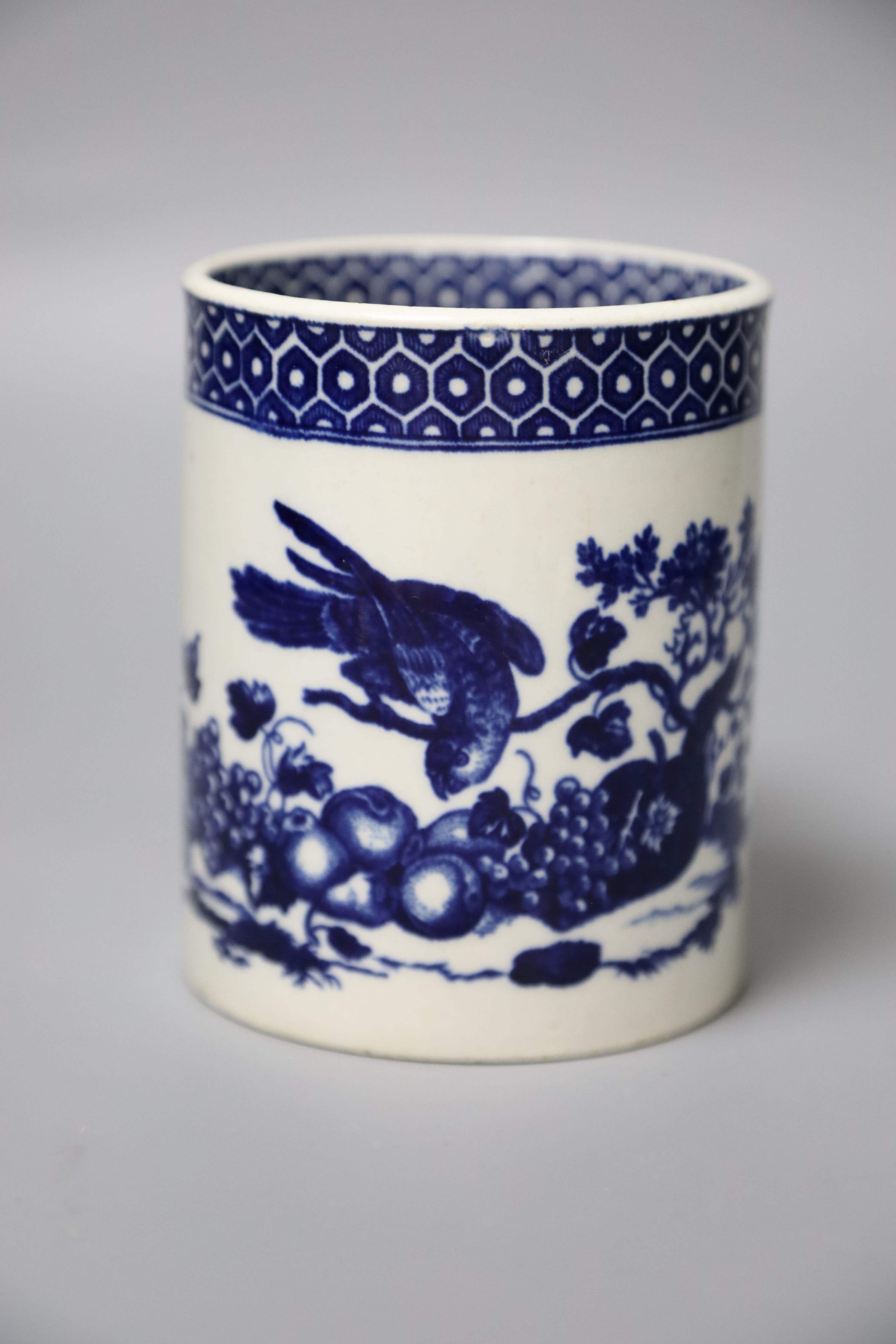 An 18th century Worcester mug printed after Hancock with Parrot Pecking Fruit pattern very rare inside and outside cell border patterns